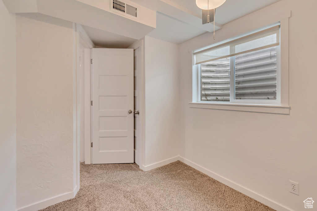 Unfurnished room featuring light colored carpet and baseboards