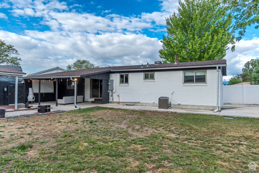 Back of house with a patio area, brick siding, and cooling unit
