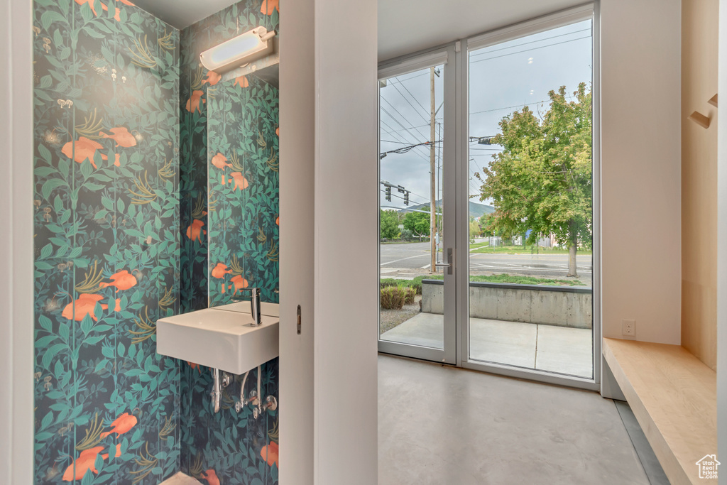 Doorway to outside with concrete floors and a sink