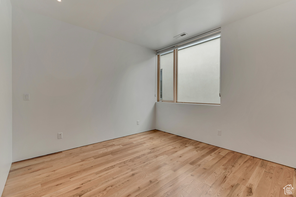 Spare room featuring wood finished floors