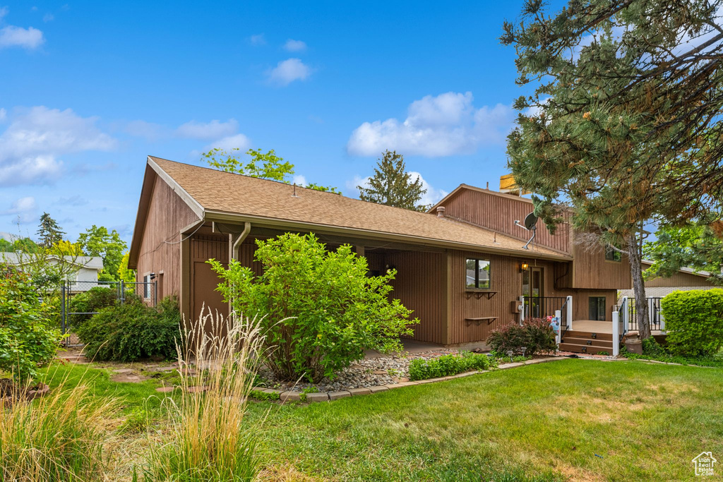 View of front of home featuring a chimney and a deck