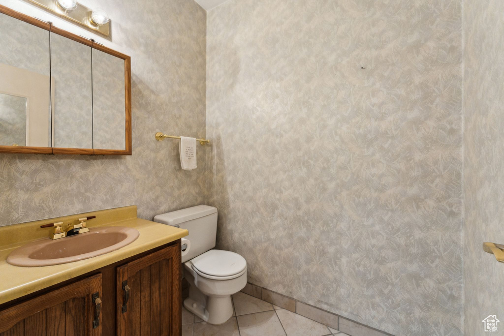Bathroom with tile patterned flooring, toilet, and vanity