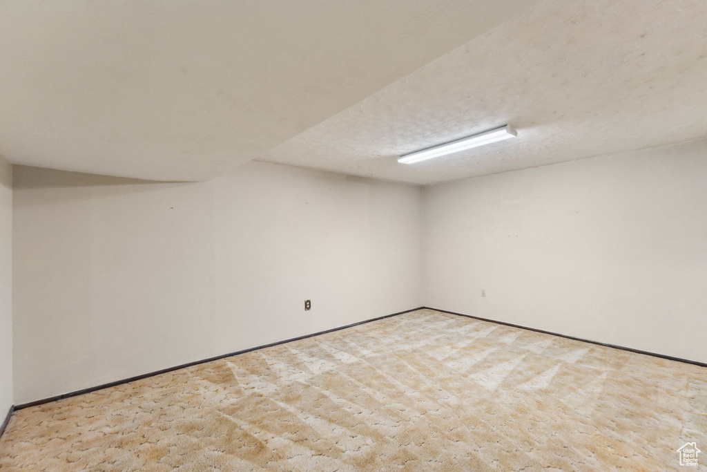 Finished basement with carpet flooring and baseboards