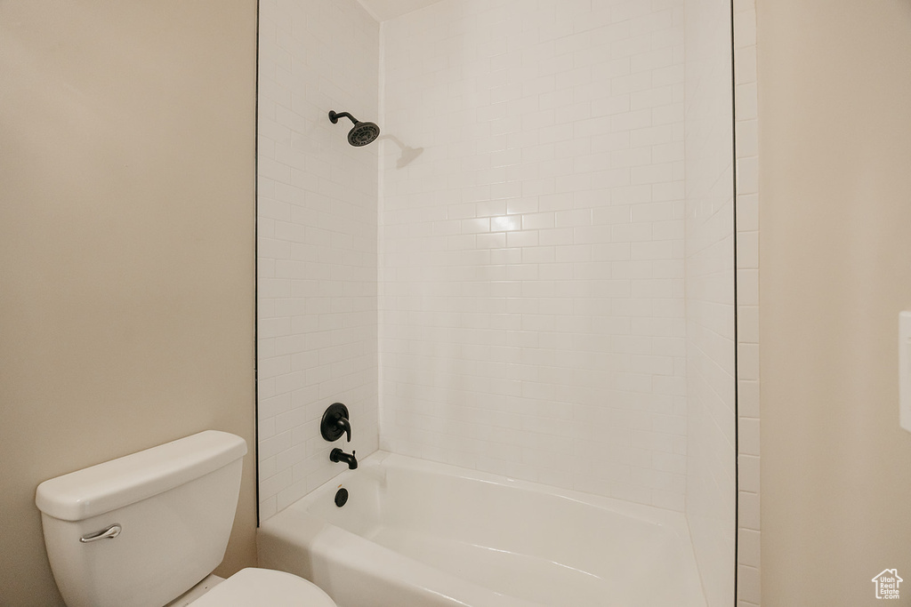 Bathroom featuring toilet and shower / tub combination