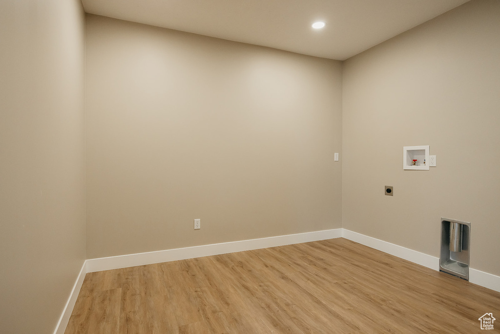 Laundry room with hookup for an electric dryer, washer hookup, light wood finished floors, baseboards, and recessed lighting