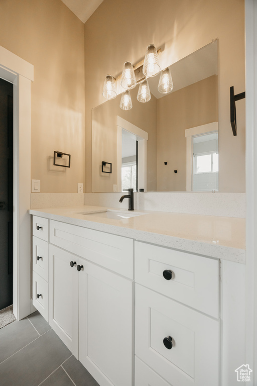 Bathroom featuring tile patterned floors and vanity