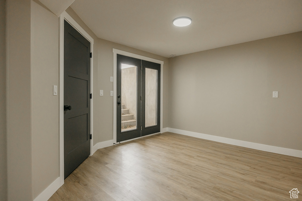 Spare room featuring light wood finished floors and baseboards