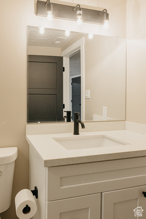 Bathroom with vanity and toilet