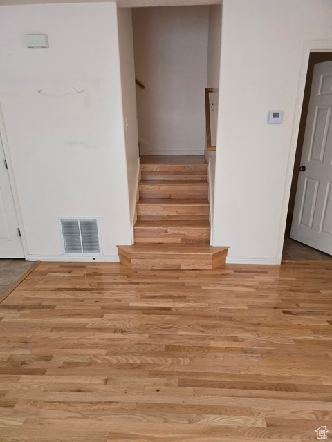 Stairs featuring wood finished floors and baseboards