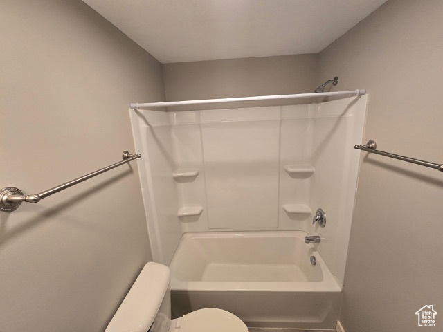 Bathroom with toilet and tub / shower combination