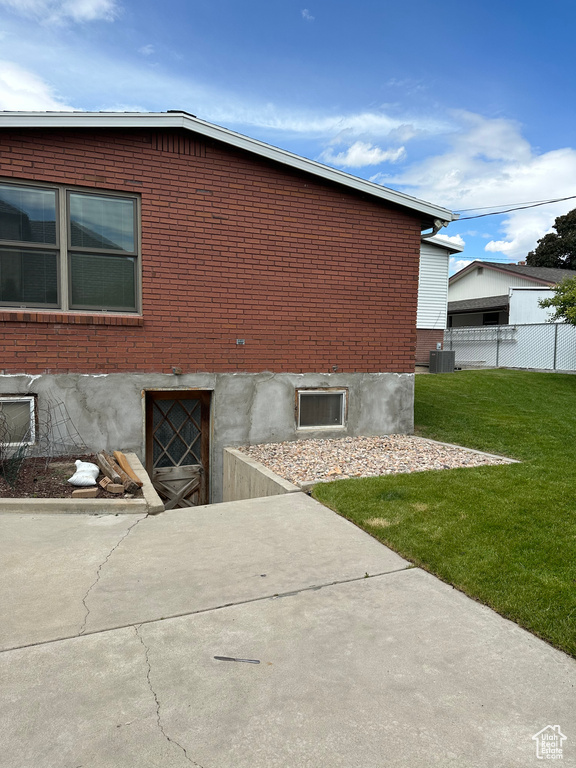 View of side of property featuring brick siding and central air condition unit