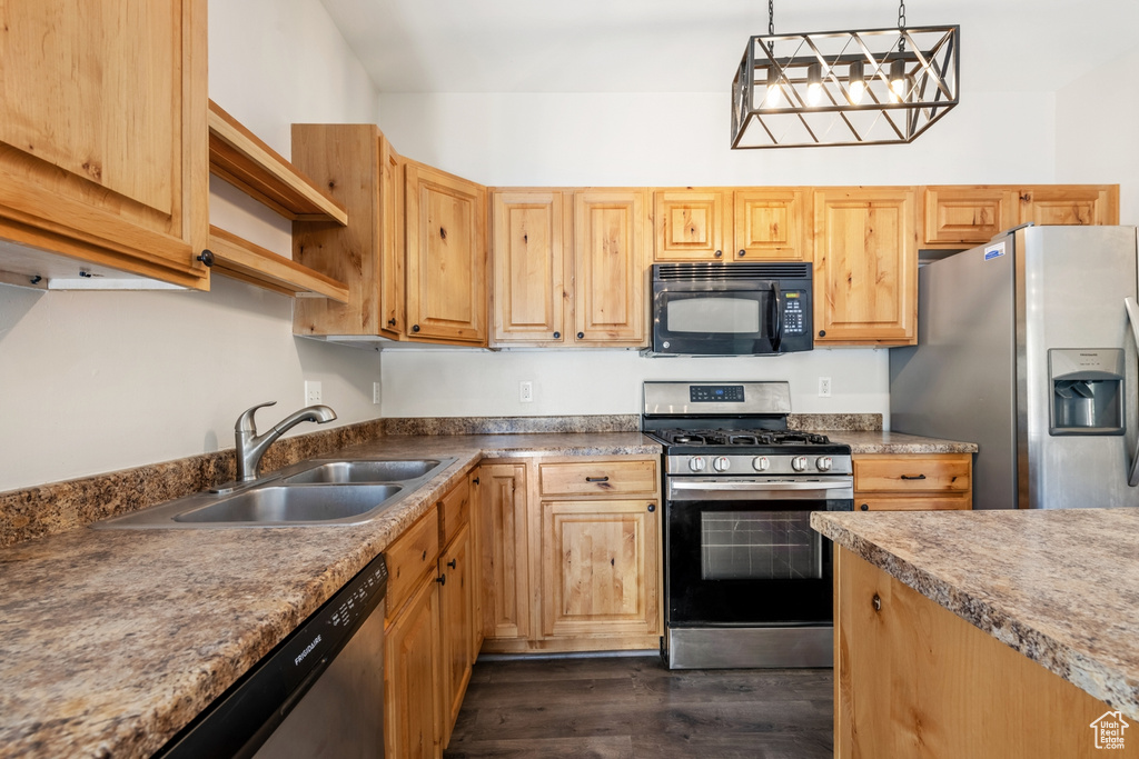 Kitchen featuring stainless steel appliances, a sink, dark wood-type flooring, pendant lighting, and open shelves