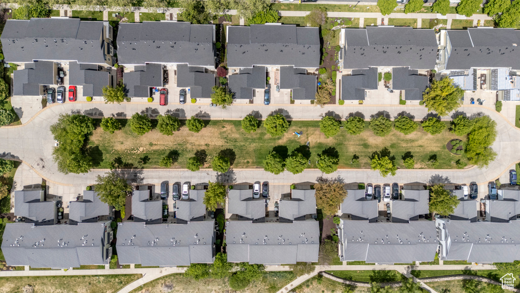 Aerial view of property and surrounding area featuring nearby suburban area