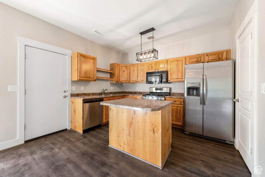Kitchen with stainless steel appliances, open shelves, dark wood-style flooring, decorative light fixtures, and a kitchen island