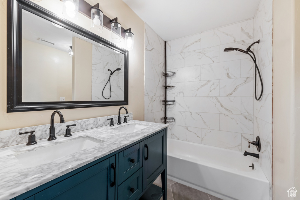 Full bathroom with bathing tub / shower combination and double vanity