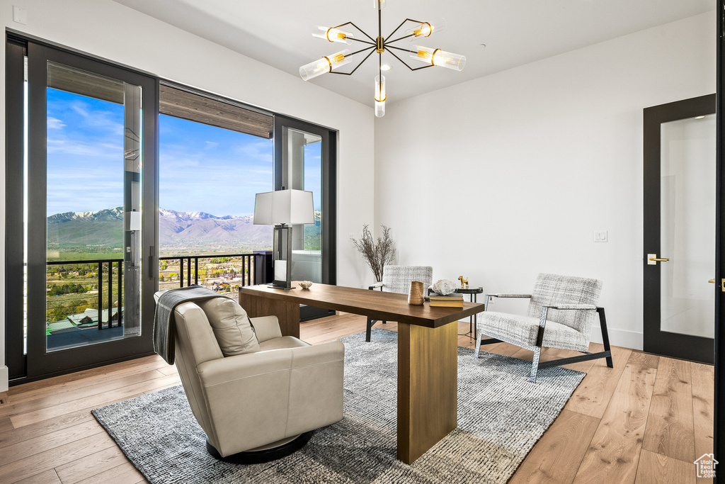 Home office featuring a mountain view, a chandelier, and hardwood / wood-style flooring