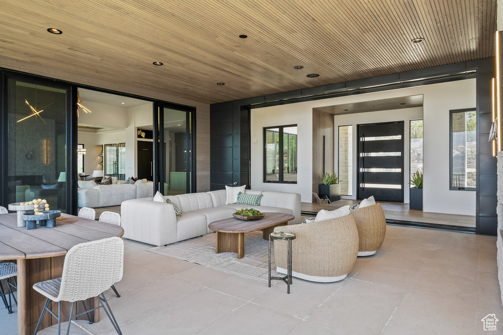 Tiled living room with plenty of natural light, recessed lighting, and wooden ceiling