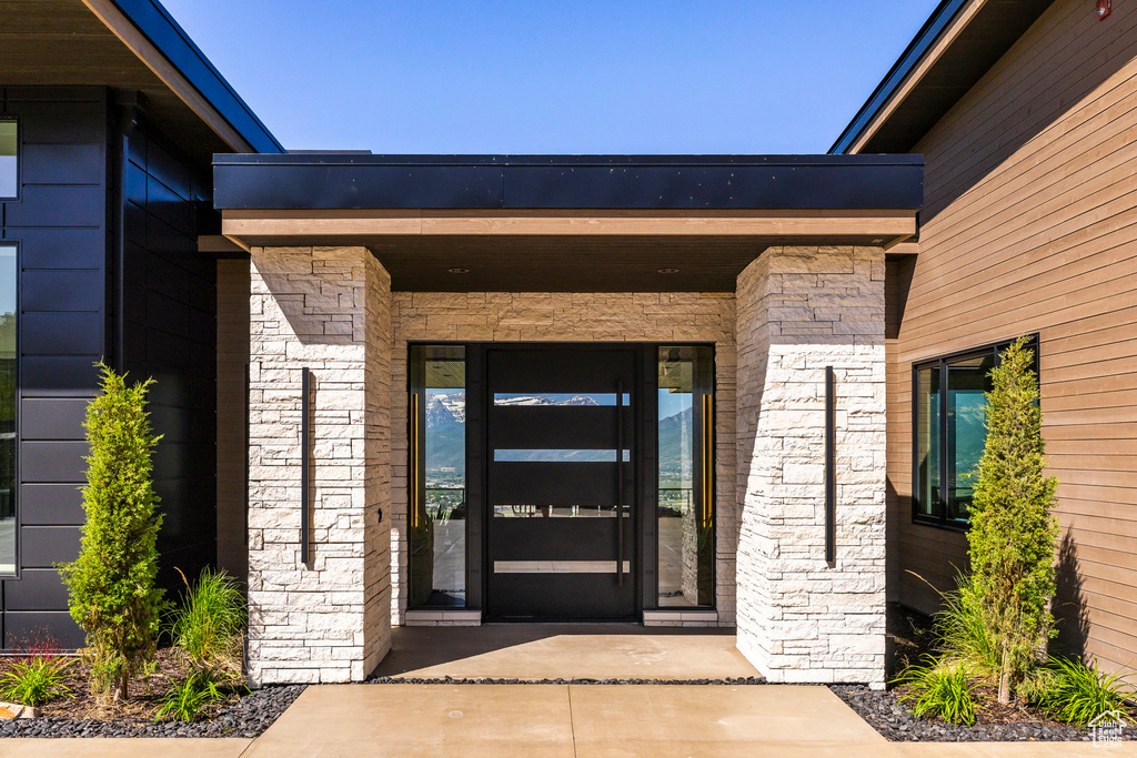 Entrance to property with stone siding