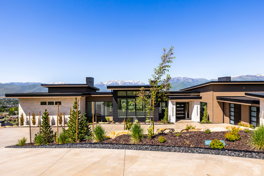 Prairie-style home featuring a mountain view and concrete driveway