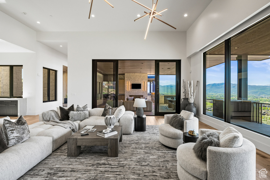 Living area with wood finished floors, recessed lighting, a chandelier, and a mountain view