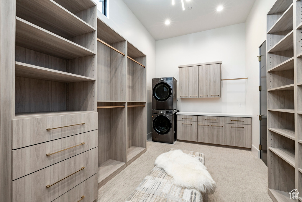 Walk in closet with stacked washer / dryer