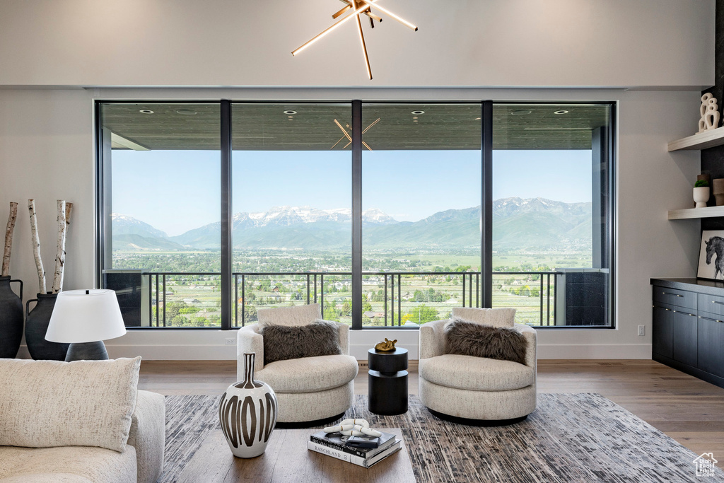 Living area with healthy amount of natural light, wood finished floors, and a mountain view