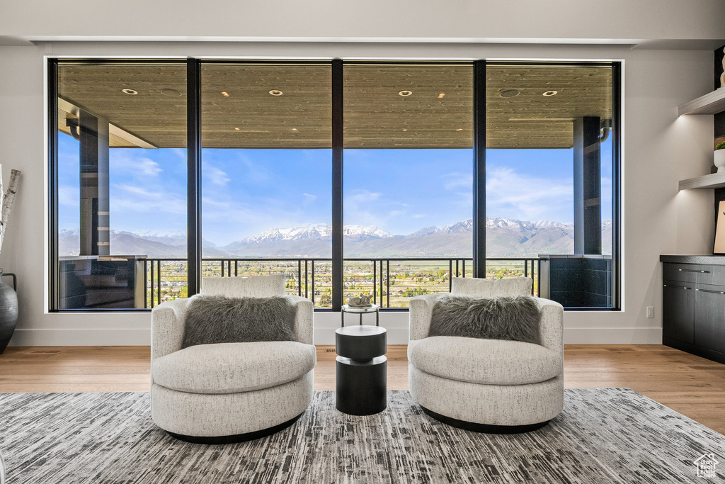 Sitting room featuring a mountain view, baseboards, and wood finished floors
