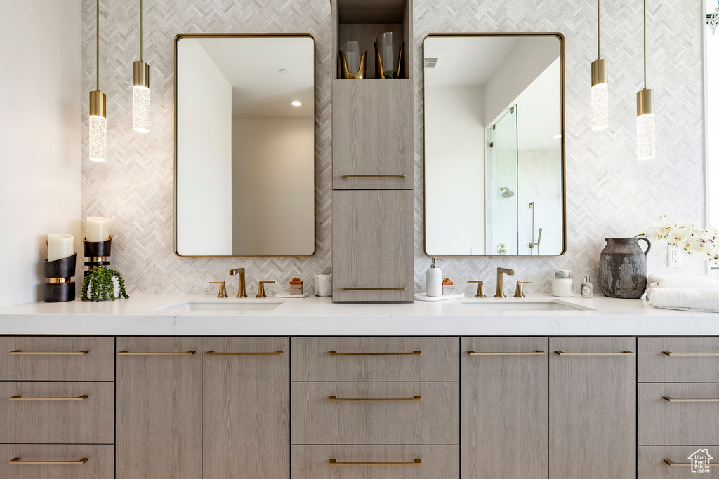 Full bathroom featuring double vanity and backsplash