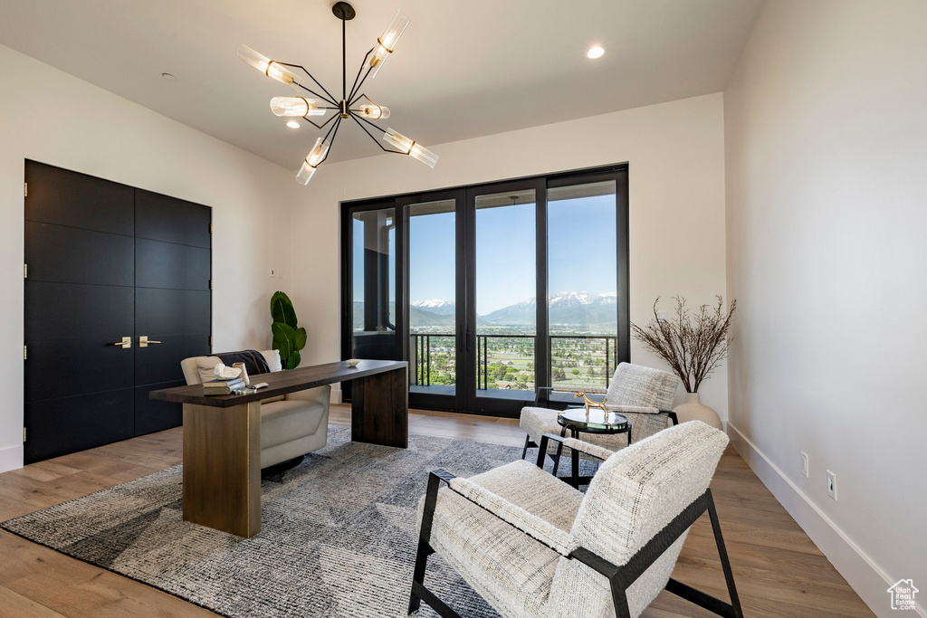 Home office featuring a mountain view, light wood finished floors, a chandelier, and recessed lighting