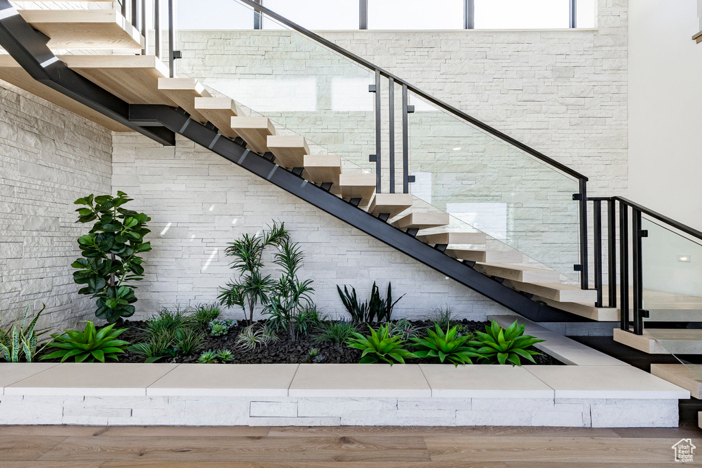 Stairway featuring wood finished floors