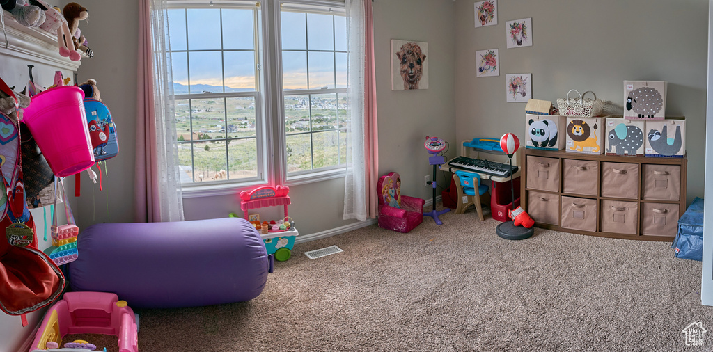 Game room featuring carpet floors and baseboards