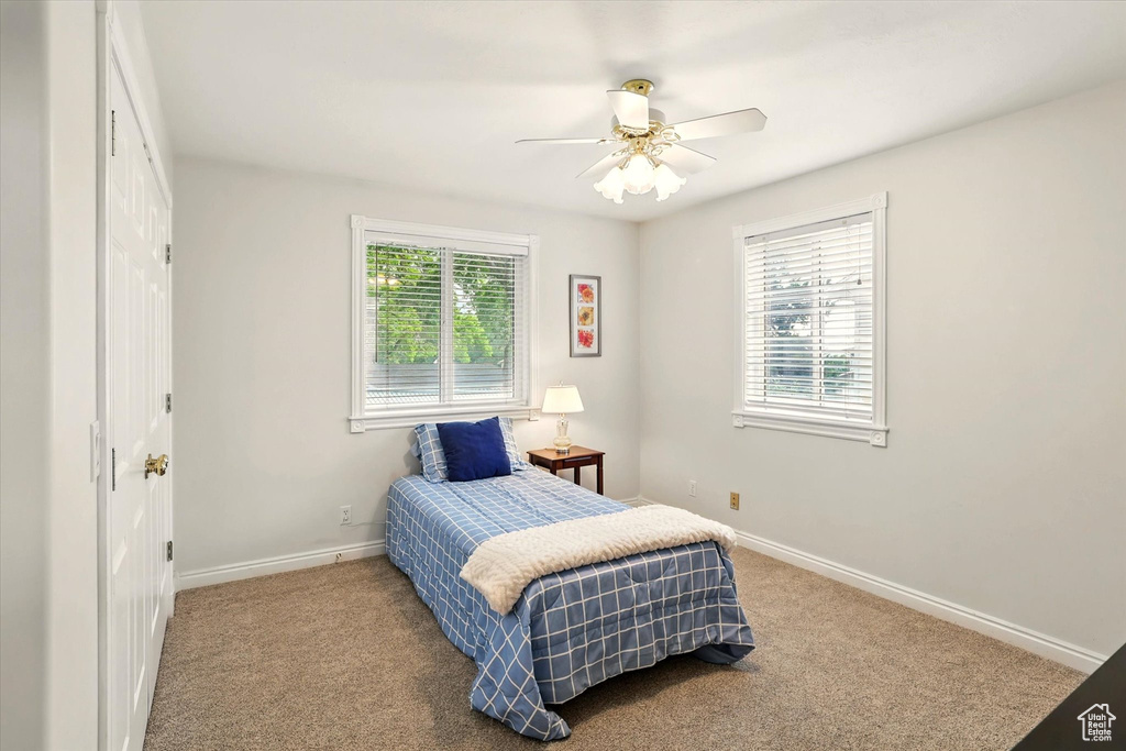 Bedroom featuring carpet flooring, baseboards, and ceiling fan