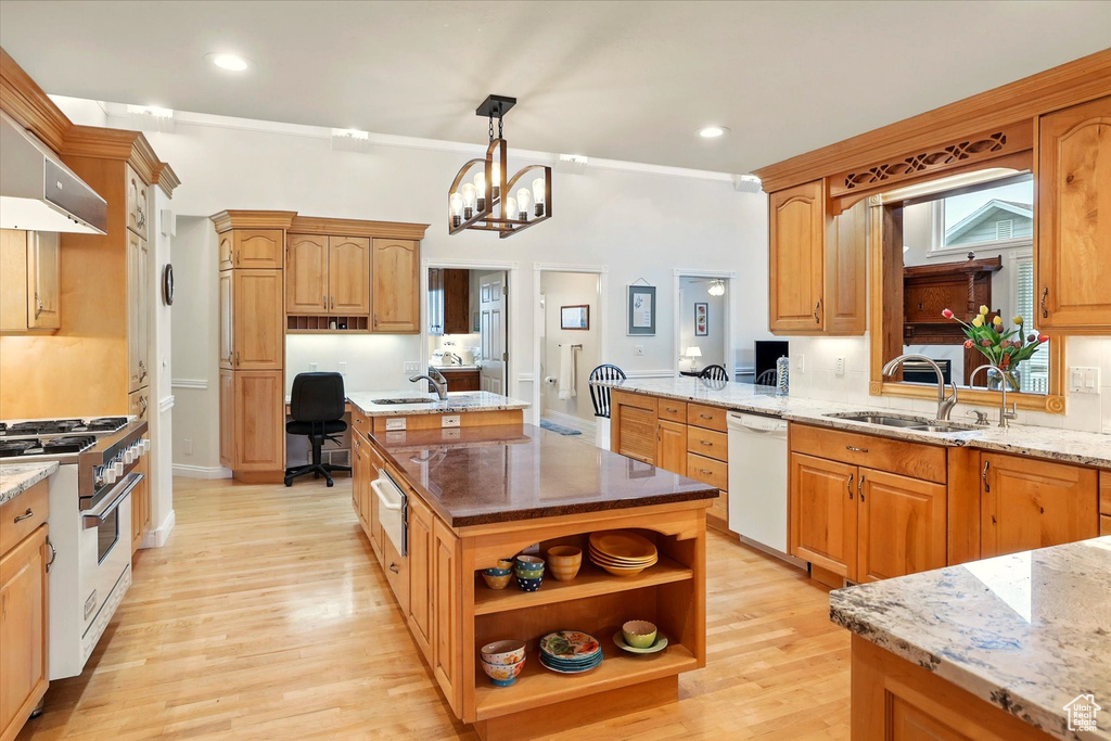 Kitchen featuring range with gas stovetop, dishwasher, a sink, a warming drawer, and a desk