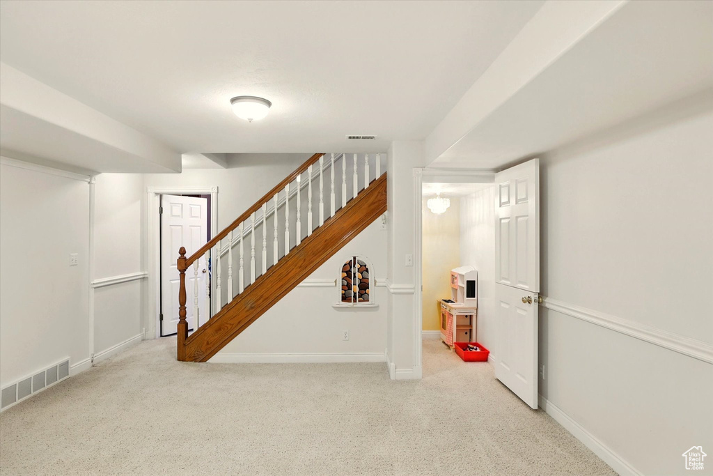 Staircase featuring carpet flooring and baseboards