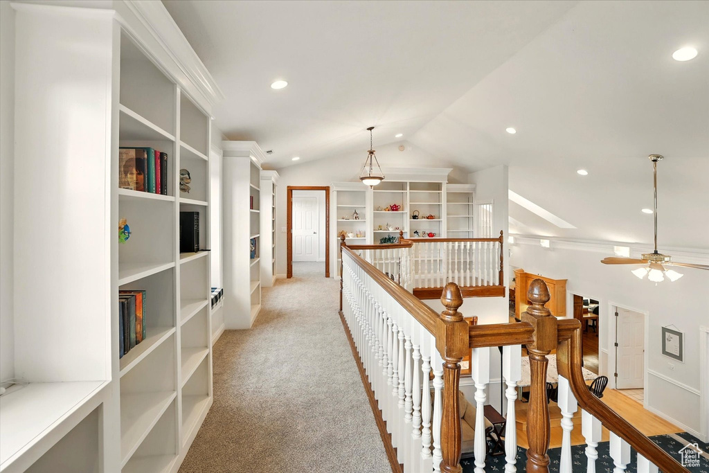 Hallway featuring an upstairs landing, vaulted ceiling, recessed lighting, and light colored carpet