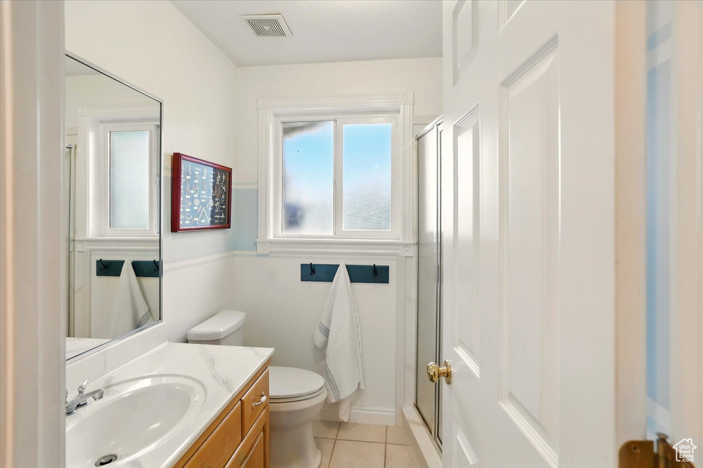 Full bathroom with tile patterned flooring, a shower stall, toilet, and vanity
