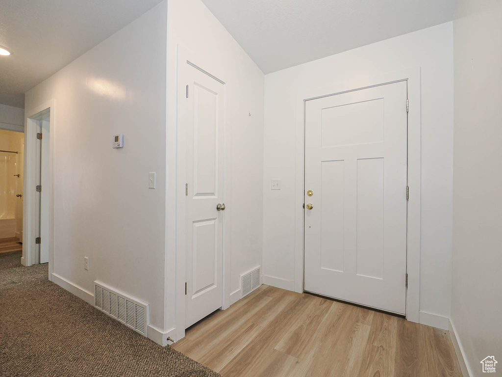 Foyer featuring light wood-style flooring and baseboards