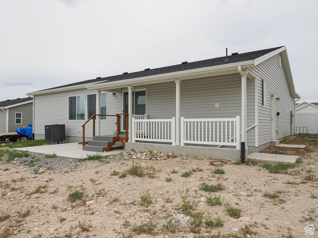 Ranch-style home featuring covered porch and central AC