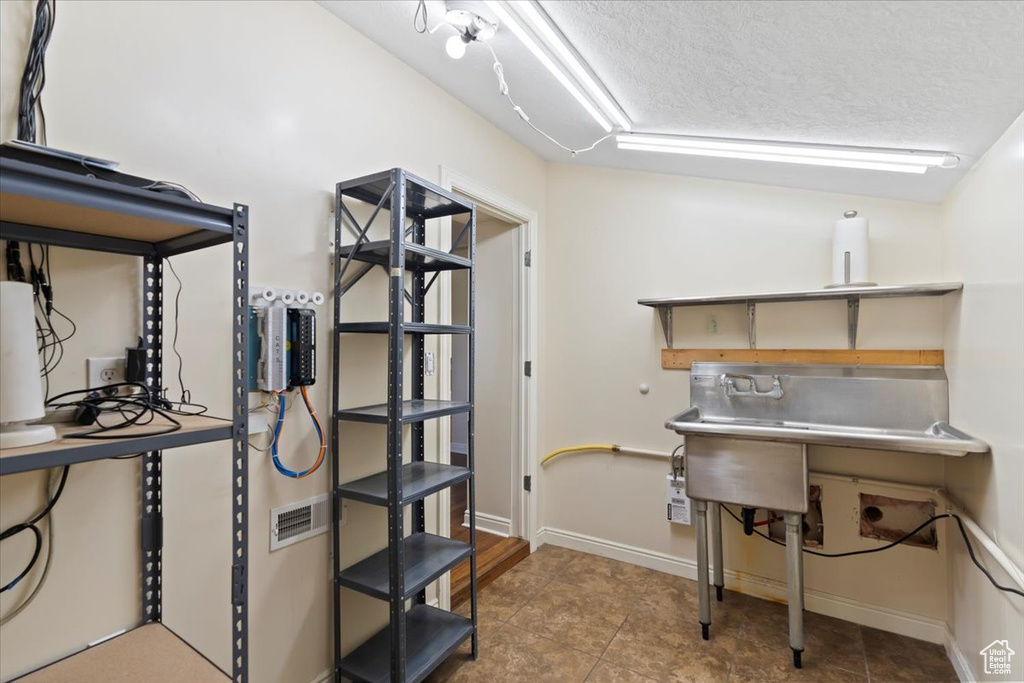 Home office with a textured ceiling and baseboards