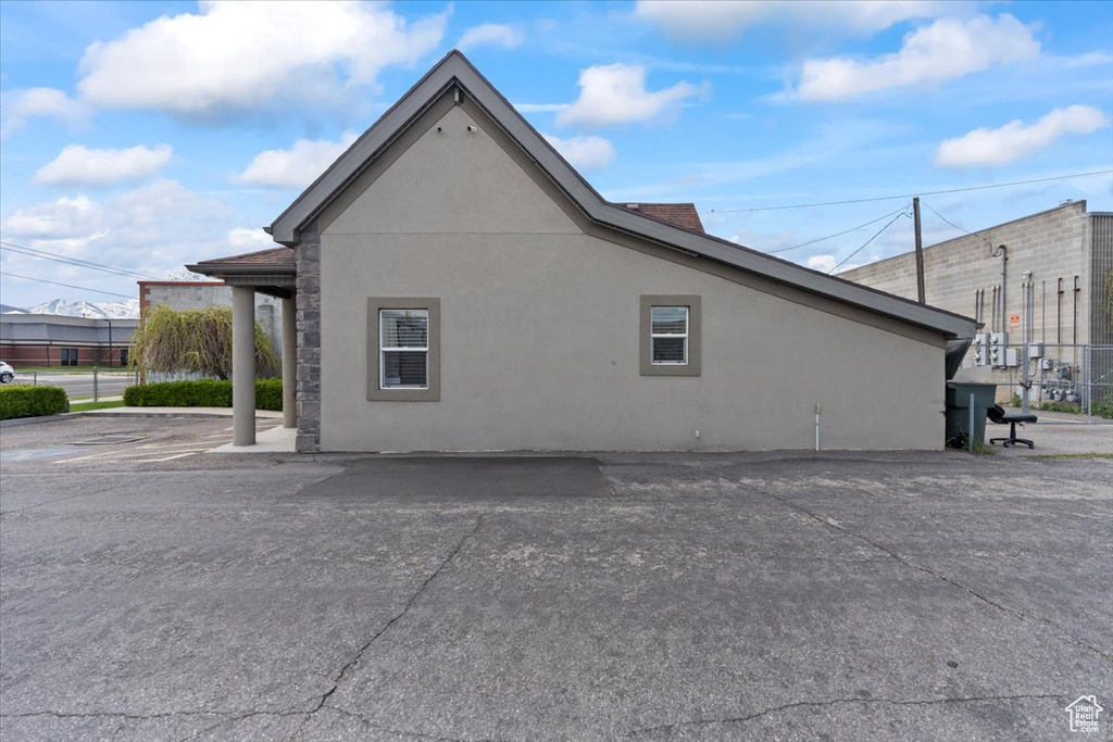 View of side of home featuring stucco siding