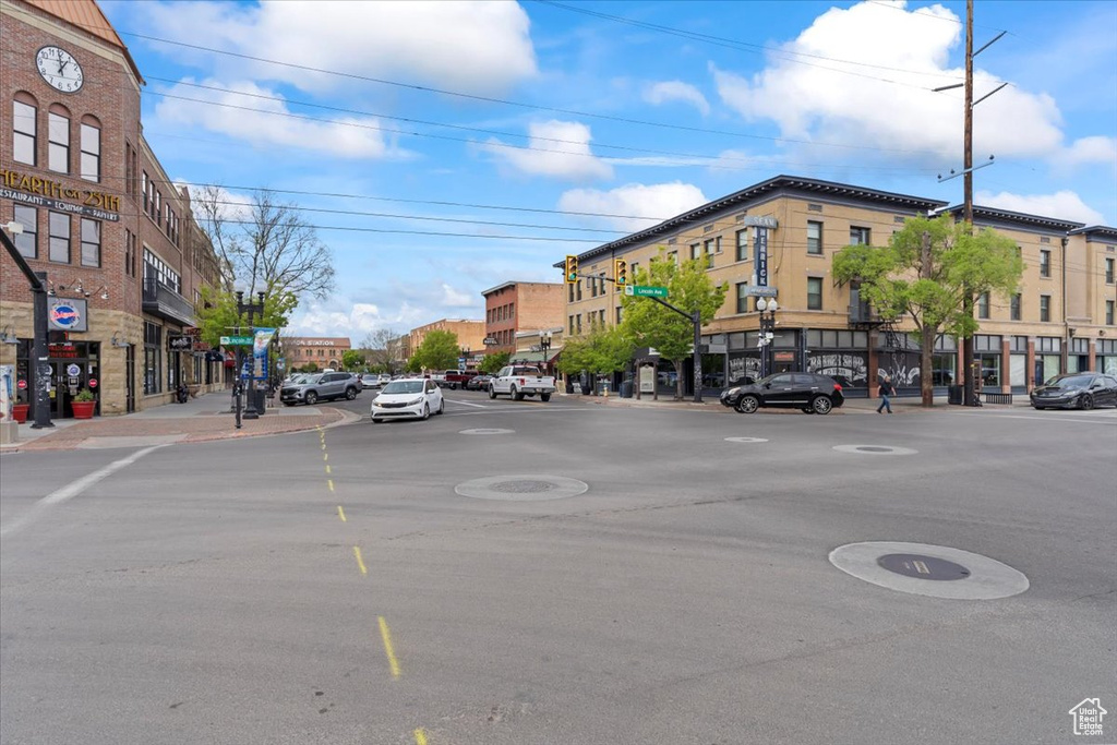 View of asphalt street with street lights, sidewalks, and curbs