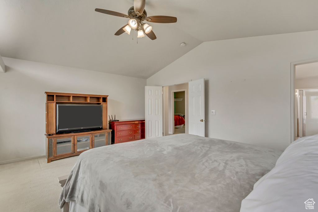 Carpeted bedroom with vaulted ceiling and ceiling fan