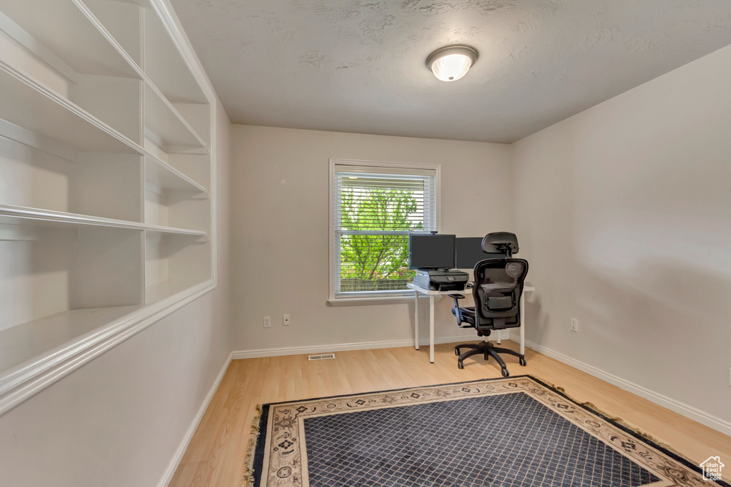 Office space with wood finished floors and baseboards