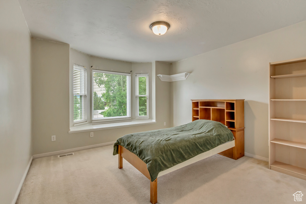 Carpeted bedroom with baseboards