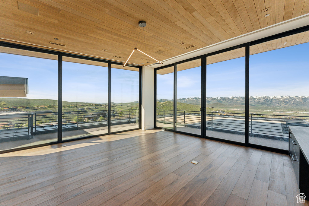 Unfurnished sunroom with a mountain view
