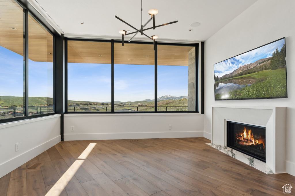 Unfurnished sunroom with a chandelier