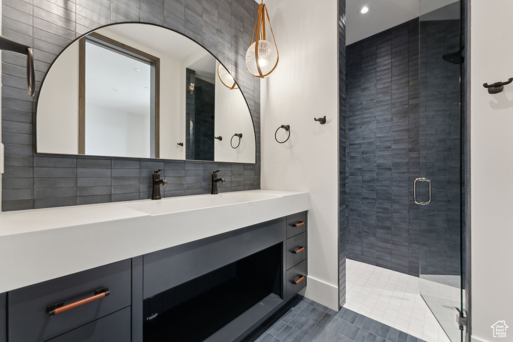 Full bathroom featuring a stall shower, vanity, tile patterned floors, recessed lighting, and backsplash