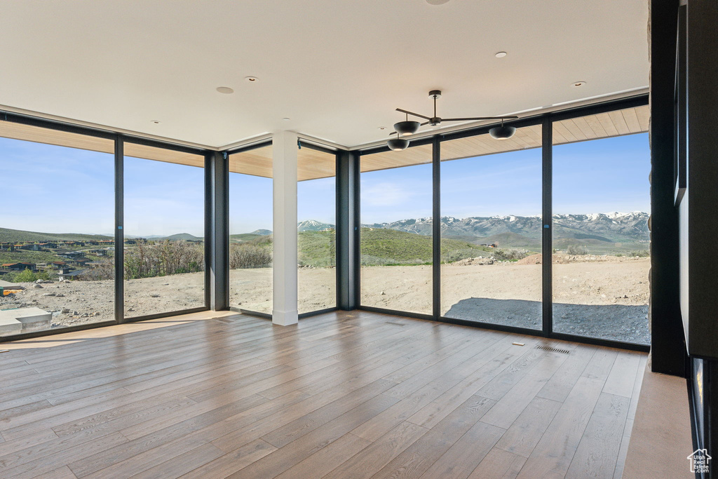 Unfurnished sunroom featuring a mountain view