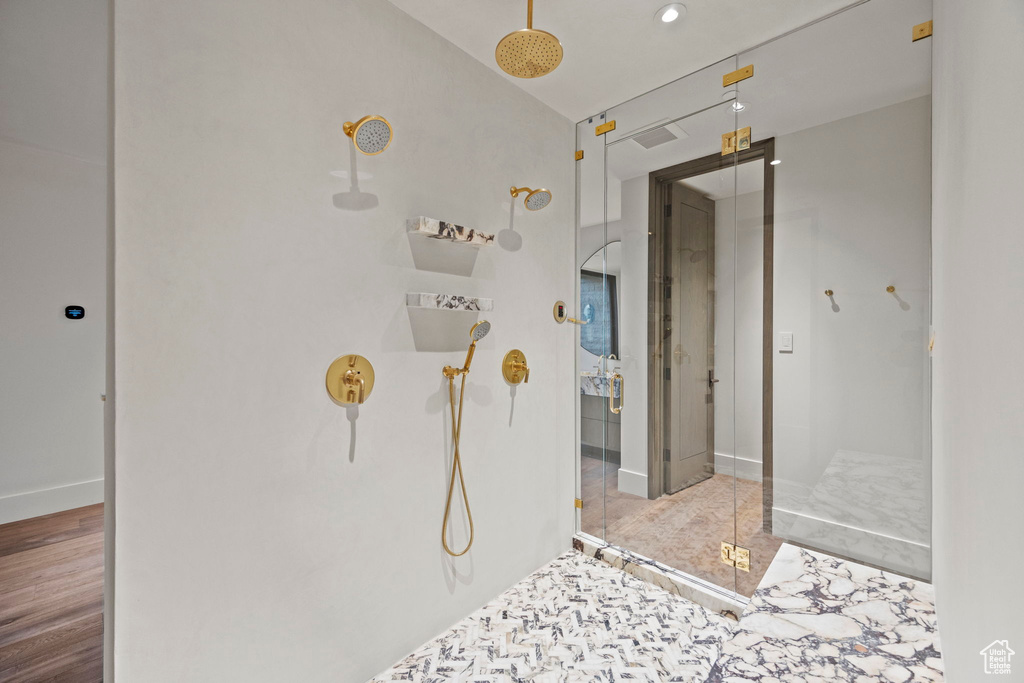 Bathroom with a walk in shower, baseboards, and recessed lighting