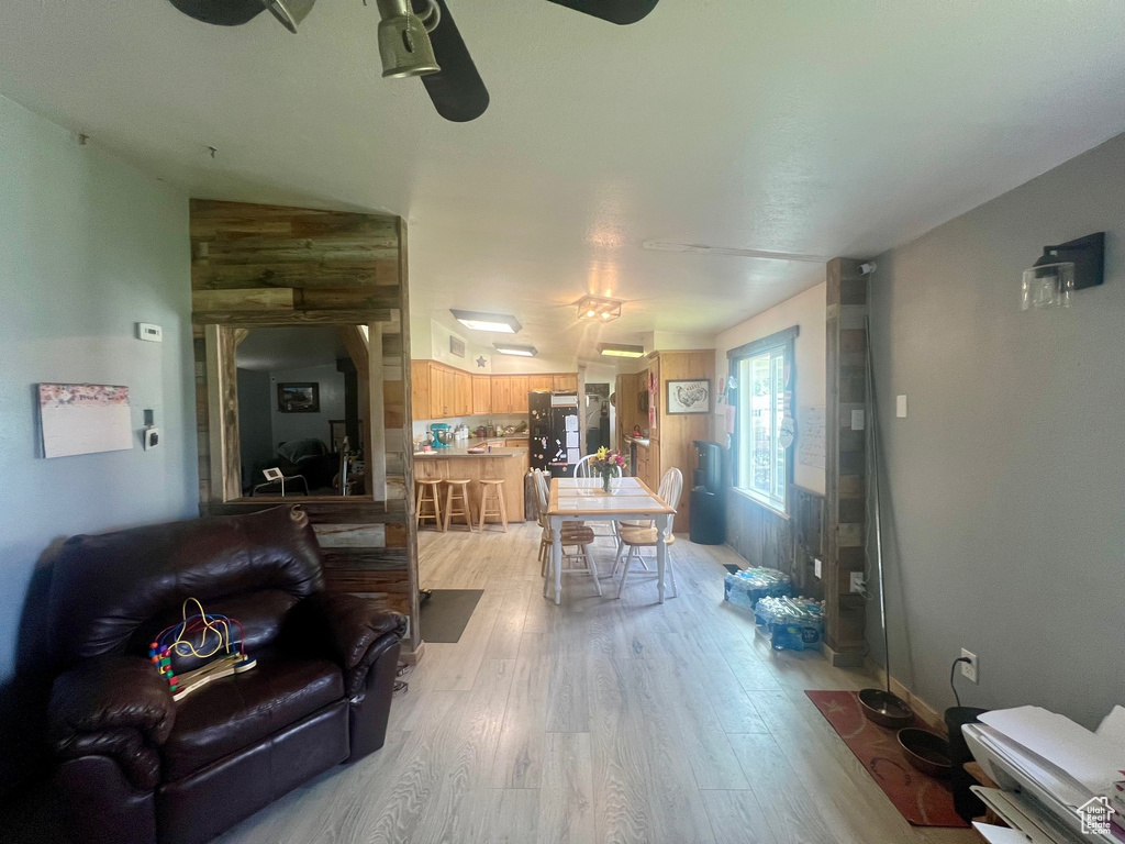 Living area featuring light wood-style flooring and a ceiling fan